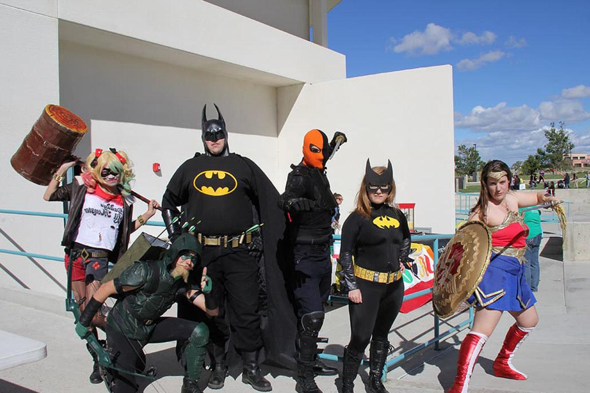 Costume contestants pose in their superhero costumes at family fun day and movie night.
